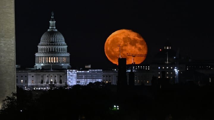 The moon rises over US capital of Washington DC