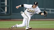 Jun 24, 2015; Omaha, NE, USA; Vanderbilt Commodores shortstop Dansby Swanson (7) tries to field a ball during the game against the Virginia Cavaliers in game three of the College World Series Finals at TD Ameritrade Park. Mandatory Credit: Steven Branscombe-Imagn Images