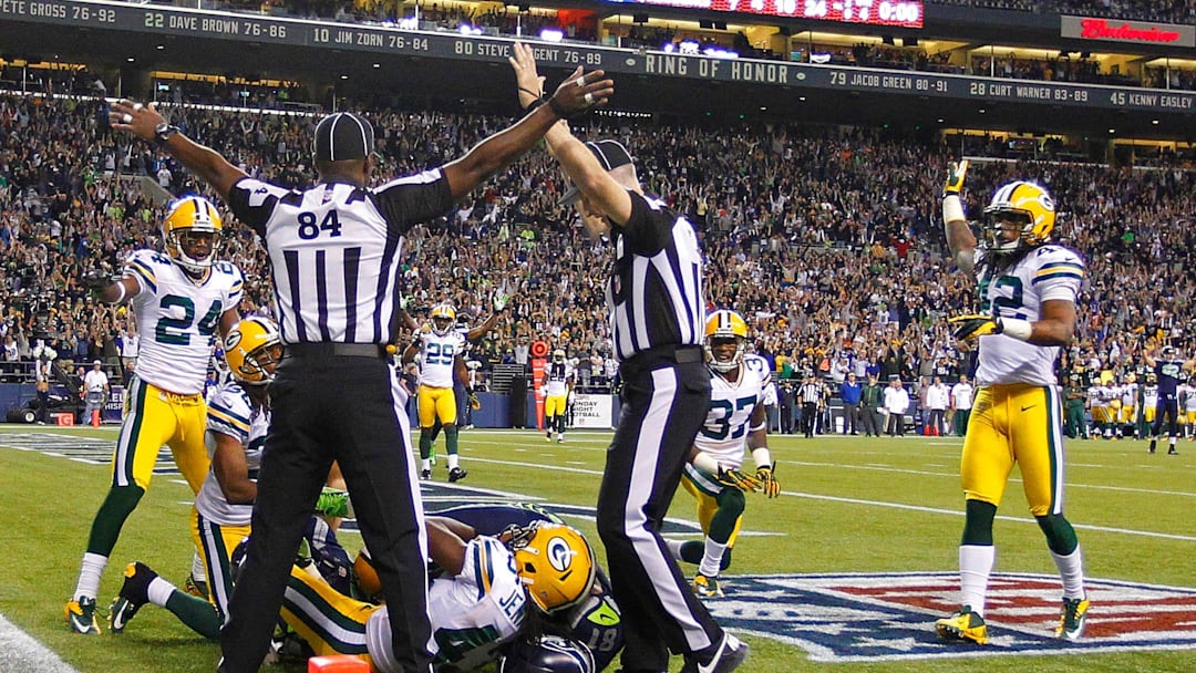 Officials indicate opposite rulings during the Green Bay Packers' 14-12 loss to the Seattle Seahawks on September 24, 2012 Officials indicate opposite rulings during the Green Bay Packers' 14-12 loss to the Seattle Seahawks on September 24, 2012