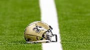 Aug 25, 2024; New Orleans, Louisiana, USA;  New Orleans Saints helmet on the turf during warmups before the game against the Tennessee Titans at Caesars Superdome. Mandatory Credit: Stephen Lew-Imagn Images