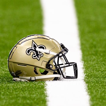 Aug 25, 2024; New Orleans, Louisiana, USA;  New Orleans Saints helmet on the turf during warmups before the game against the Tennessee Titans at Caesars Superdome. Mandatory Credit: Stephen Lew-Imagn Images