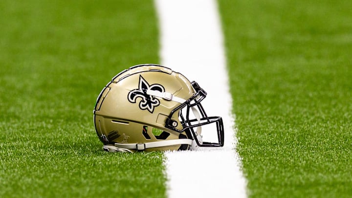 Aug 25, 2024; New Orleans, Louisiana, USA;  New Orleans Saints helmet on the turf during warmups before the game against the Tennessee Titans at Caesars Superdome. Mandatory Credit: Stephen Lew-Imagn Images