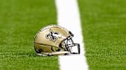 Aug 25, 2024; New Orleans, Louisiana, USA;  New Orleans Saints helmet on the turf during warmups before the game against the Tennessee Titans at Caesars Superdome. Mandatory Credit: Stephen Lew-Imagn Images