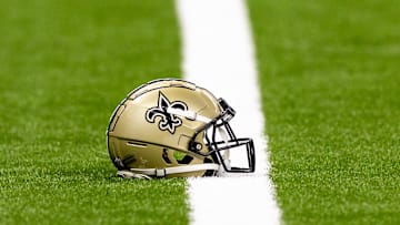 Aug 25, 2024; New Orleans, Louisiana, USA;  New Orleans Saints helmet on the turf during warmups before the game against the Tennessee Titans at Caesars Superdome. Mandatory Credit: Stephen Lew-Imagn Images