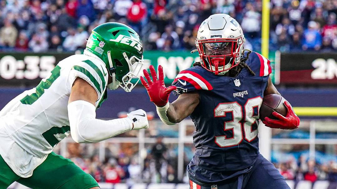 Oct 27, 2024; Foxborough, Massachusetts, USA; New England Patriots running back Rhamondre Stevenson (38) runs the ball against New York Jets cornerback Isaiah Oliver (23) in the second half at Gillette Stadium. Mandatory Credit: David Butler II-Imagn Images