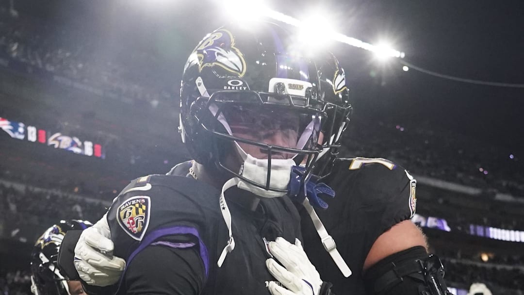 Dec 21, 2025; Baltimore, Maryland, USA;  Baltimore Ravens wide receiver Zay Flowers (4) celebrates his touchdown against the New England Patriots with teammates during the second half of the game at M&T Bank Stadium. Mandatory Credit: James Lang-Imagn Images