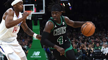 Jan 27, 2024; Boston, Massachusetts, USA;  Boston Celtics guard Jrue Holiday (4) controls the ball while LA Clippers guard Terance Mann (14) defends during the second half at TD Garden. Mandatory Credit: Bob DeChiara-Imagn Images
