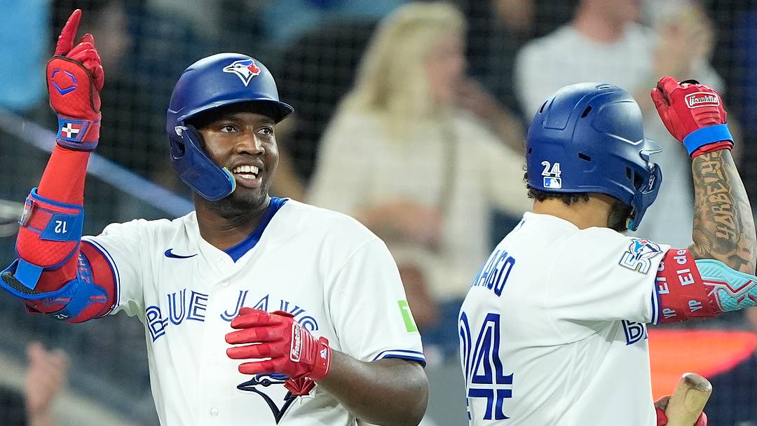 Toronto Blue Jays left fielder Jesus Sanchez (12) celebrates his solo home run with left fielder Yohendrick Pinango (24). 