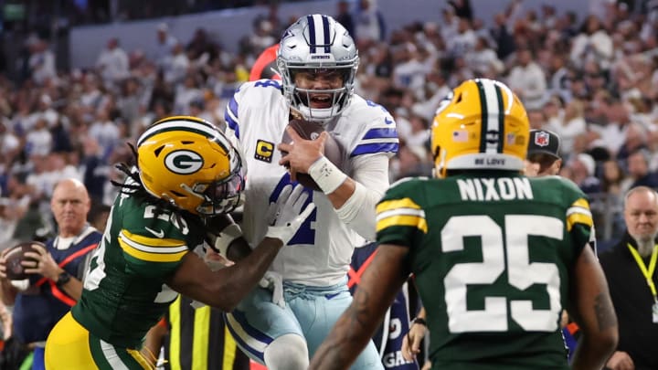 Dallas Cowboys quarterback Dak Prescott rushes for a touchdown against Green Bay Packers safety Darnell Savage during the second half for the 2024 NFC wild card game at AT&T Stadium.