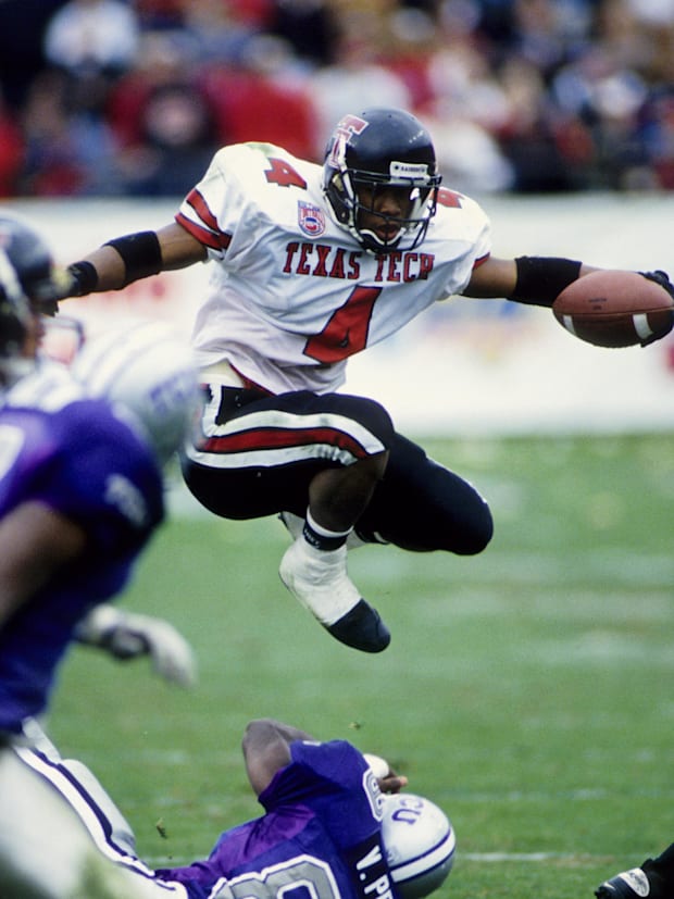 Texas Tech running back Byron Hanspard (4) hurdles a TCU's Vincent Pryor (89) at Amon G. Carter Stadium in 1994.