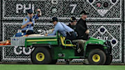 Stadium security and Pittsburgh Pirates medical personnel cart a fan who fell from the stands to the field to an ambulance.