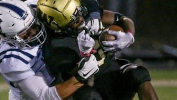 Iowa City West’s Butali Butali (35) is tackled by Pleasant Valley’s Joey VanWetzinga (50) Friday, Oct. 18, 2024 in Iowa City, Iowa.