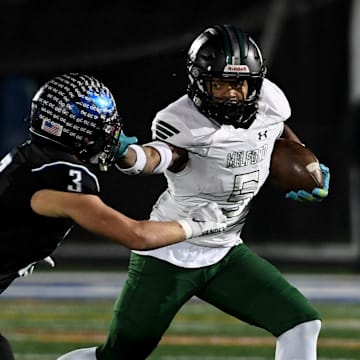 Decatur's Gavin Solito (3) tackles Milford Mill's Damon Ferguson (5) Friday, Nov. 24, 2023, in the 2A State Semifinal in Berlin, Maryland. Decatur defeated Milford Mill 35-34.