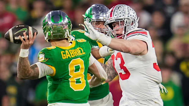 Ohio State Buckeyes defensive end Jack Sawyer (33) pursues Oregon Ducks quarterback Dillon Gabriel (8)