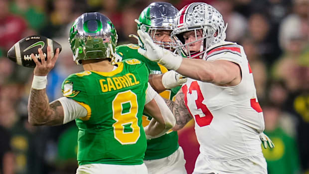 Ohio State Buckeyes defensive end Jack Sawyer (33) pursues Oregon Ducks quarterback Dillon Gabriel (8) during the College Foo