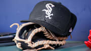Jul 15, 2023; Atlanta, Georgia, USA; A detailed view of a Chicago White Sox hat and glove in the dugout against the Atlanta Braves in the first inning at Truist Park. Mandatory Credit: Brett Davis-Imagn Images