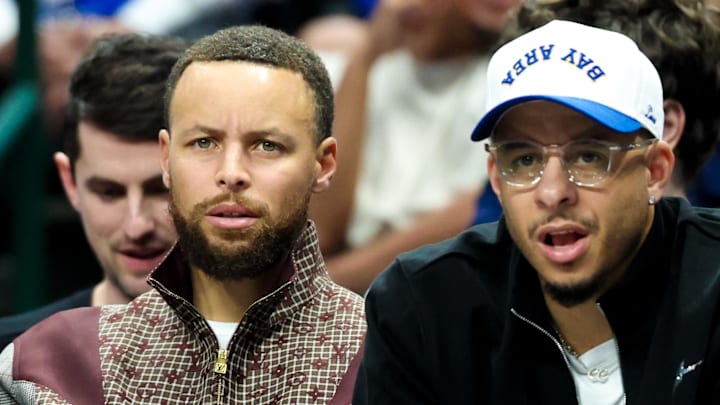 Mar 23, 2026; Dallas, Texas, USA;  Golden State Warriors guard Stephen Curry (left) sits with Golden State Warriors guard Seth Curry (right) during the first half against the Dallas Mavericks at American Airlines Center. Mandatory Credit: Kevin Jairaj-Imagn Images