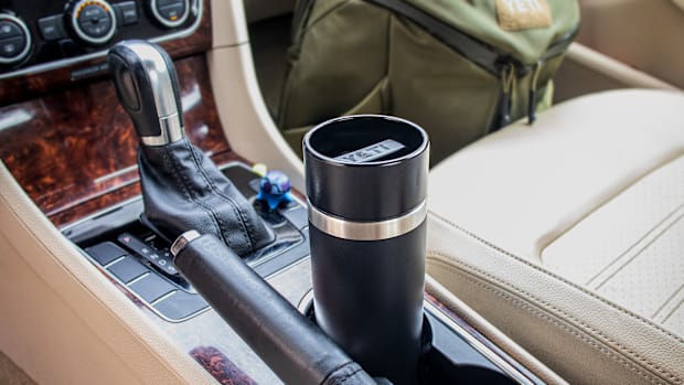 The YETI Rambler Travel Bottle in the cup holder of a car.