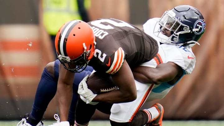 Tennessee Titans cornerback Roger McCreary (21) tackles Cleveland Browns wide receiver Amari Cooper (2) during the first quarter in Cleveland, Ohio., Sunday, Sept. 24, 2023.