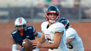 Magnolia Heights quarterback Cole Prosek (6) looks for an opening against Madison Ridgeland Academy during play in Madison, Miss., Friday, Aug. 18, 2023.