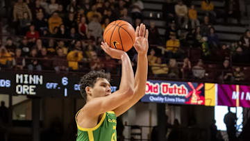 Jan 25, 2025; Minneapolis, Minnesota, USA;  Oregon Ducks forward Brandon Angel (21) shoots a three-point basket against the Minnesota Golden Gophers during the second half at Williams Arena. Mandatory Credit: Nick Wosika-Imagn Images