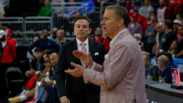 St. John's basketball head coach Rick Pitino, left, approaches Coach John Calipari as their March Madness game is about to end on Saturday.