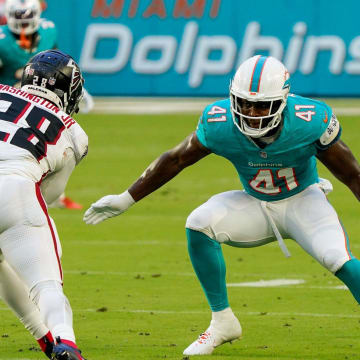 Miami Dolphins linebacker Channing Tindall (41) makes a tackle in the first quarter during a preseason game at Hard Rock Stadium on Friday, August 11, 2023, in Miami Gardens, FL.