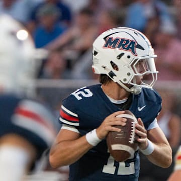 MRA quarterback Samuel Stockett (12) looks for an opening during play against Ravenwood in Madison, Miss., Friday, Aug. 22, 2025.