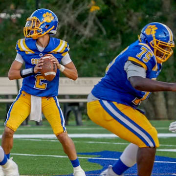 Quarterback Jayden Allard (2) looks downfield as he prepares to throw a touchdown pass for North Providence.