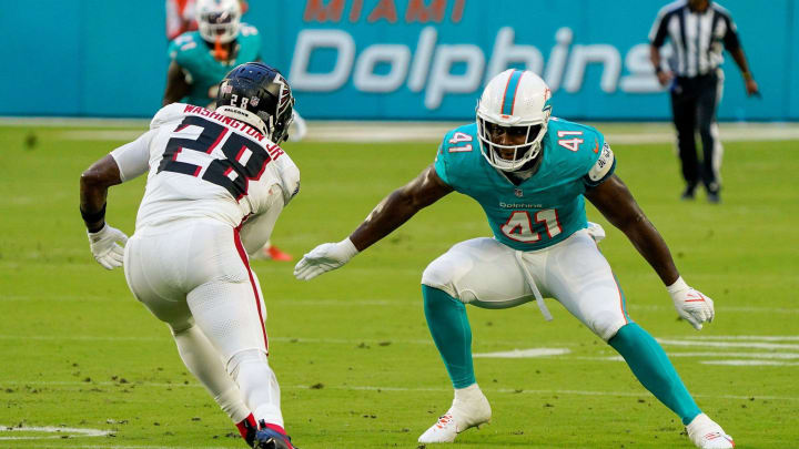 Miami Dolphins linebacker Channing Tindall (41) makes a tackle in the first quarter during a preseason game at Hard Rock Stadium on Friday, August 11, 2023, in Miami Gardens, FL.