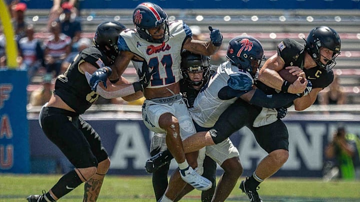 Army Black Knights quarterback Bryson Daily #13, right, carries the ball during NCAA college football action as the Florida Atlantic University Owls host Army's Black Knights on September 7, 2024, in Boca Raton, Fla. Army led 14-7 at halftime.