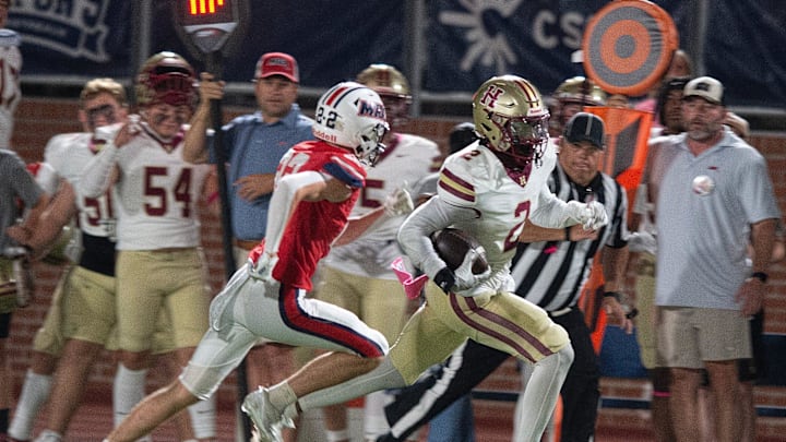With an MRA defender at his heals, Hartfield's Bralan Womack (2) carries for yardage in Madison, Miss., Friday, Oct. 11, 2024. With an MRA defender at his heals, Hartfield's Bralan Womack (2) carries for yardage in Madison, Miss., Friday, Oct. 11, 2024.