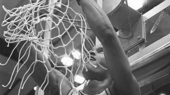 Chester Dorsey cuts the net after a UW game.