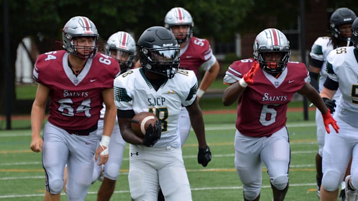 Christian Mena (18) competes for the St. John's Catholic Prep football team. Christian Mena (18) competes for the St. John's Catholic Prep football team.