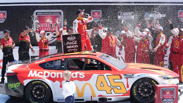 Tyler Reddick celebrates in Victory Lane after winning the FireKeepers Casino 400 at Michigan International Speedway.