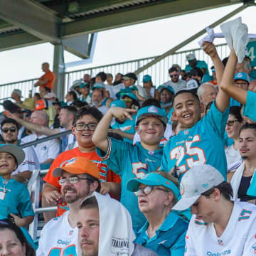 Miami Dolphins fans cheer at training camp at Baptist Health Training Complex last summer.