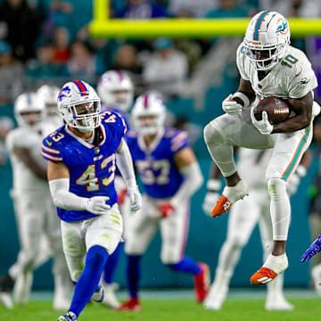 Miami Dolphins wide receiver Tyreek Hill (10) leaps to make a catch for a first down in front of Buffalo Bills safety Taylor Rapp (20), during second half action of their NFL football game Jan 07, 2024, in Miami Gardens.