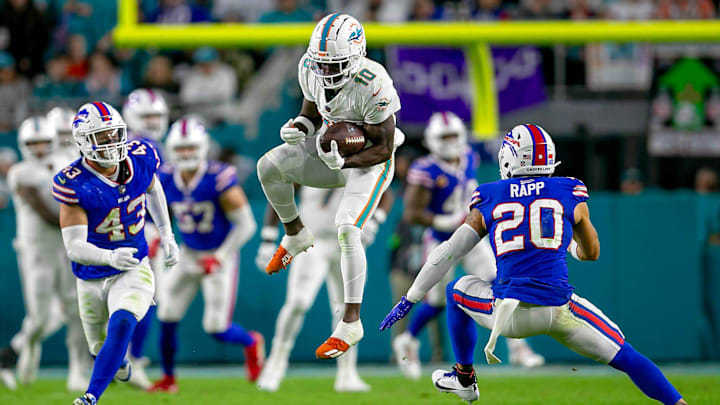 Miami Dolphins wide receiver Tyreek Hill (10) leaps to make a catch for a first down in front of Buffalo Bills safety Taylor Rapp (20), during second half action of their NFL football game Jan 07, 2024, in Miami Gardens.