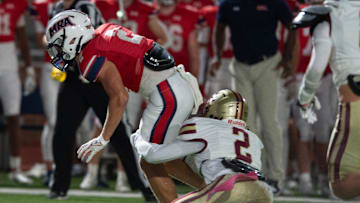 MRA's Case Thomas( 2) tries to break a tackle by Hartfield's Bralan Womack (2) in Madison, Miss., Friday, Oct. 11, 2024.