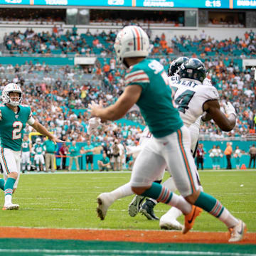 Miami Dolphins holder Matt Haack (2) throws a touchdown pass to Miami Dolphins kicker Jason Sanders (7) on a fake field goal attempt in the second quarter against the Philadelphia Eagles in Miami Gardens, Dec. 1, 2019.