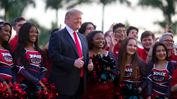 President Donald J. Trump poses for a photo with Florida Atlantic University cheerleaders and members of the marching band outside Trump International Golf Club, Sunday, February 3, 2019. President Trump was arriving for his annual Super Bowl watch party at his golf club in West Palm Beach. [ALLEN EYESTONE/palmbeachpost.com]