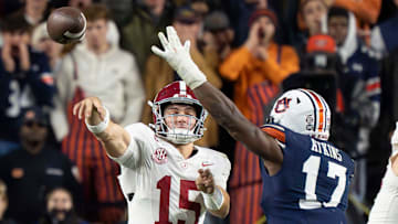 Alabama quarterback Ty Simpson (15) throws under pressure from Auburn linebacker Xavier Atkins (17)