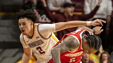 Jan 6, 2025; Minneapolis, Minnesota, USA;  Ohio State Buckeyes guard Ques Glover (6) is fouled by Minnesota Golden Gophers guard Mike Mitchell Jr. (2) during the second overtime at Williams Arena. Mandatory Credit: Nick Wosika-Imagn Images