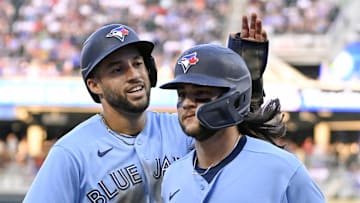 May 26, 2023; Minneapolis, Minnesota, USA;  Toronto Blue Jays outfielder George Springer (4) congratulates infielder Bo Bichette (11) on his two-run home run against the Minnesota Twins during the third inning at Target Field. Mandatory Credit: Nick Wosika-Imagn Images