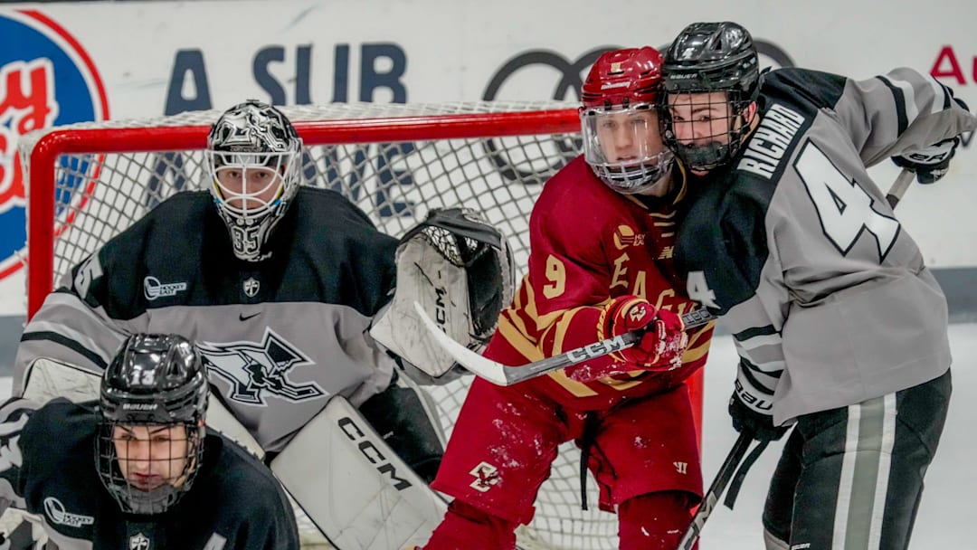 Guillaume Richard defends BC's Ryan Leonard, with goalie John Driscoll. PC beats number one ranked Boston College.