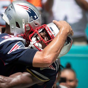 Tom Brady and Antonio Brown embrace.