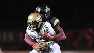 Oaks Christian's Hayden Lowe brings down St. Bonaventure's quarterback Jaxson Carper during the second quarter of Oaks Christian's 35-0 Marmonte League win over visiting St. Bonaventure Friday at Redell Field.