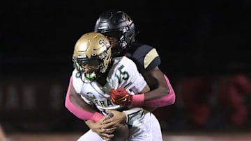 Oaks Christian's Hayden Lowe brings down St. Bonaventure's quarterback Jaxson Carper during the second quarter of Oaks Christian's 35-0 Marmonte League win over visiting St. Bonaventure Friday at Redell Field.