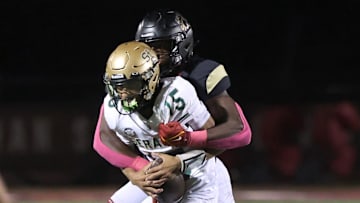 Oaks Christian's Hayden Lowe brings down St. Bonaventure's quarterback Jaxson Carper during the second quarter of Oaks Christian's 35-0 Marmonte League win over visiting St. Bonaventure Friday at Redell Field.