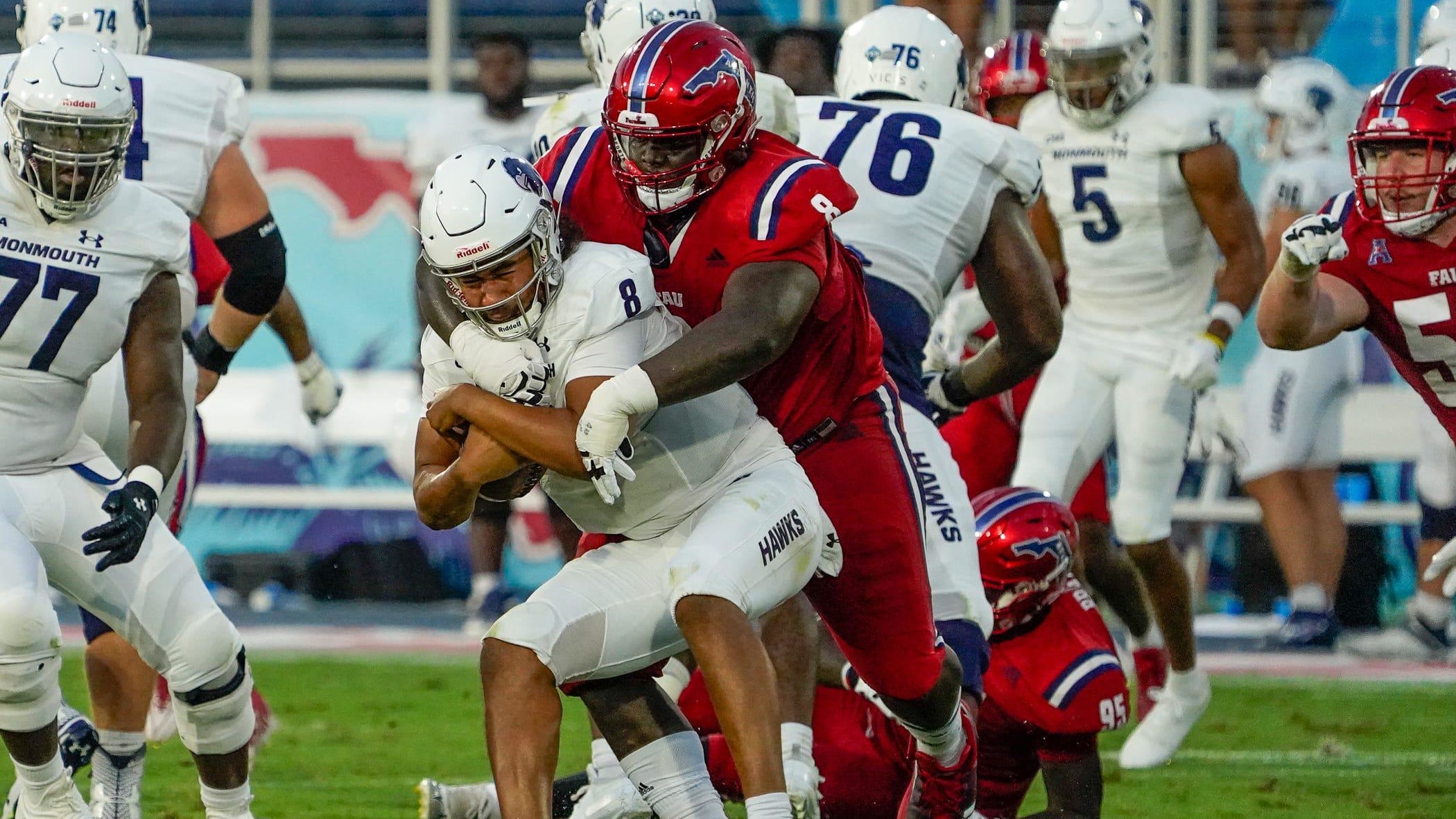 Florida Atlantic defensive tackle Evan Anderson (8) sacks the Monmouth quarterback.